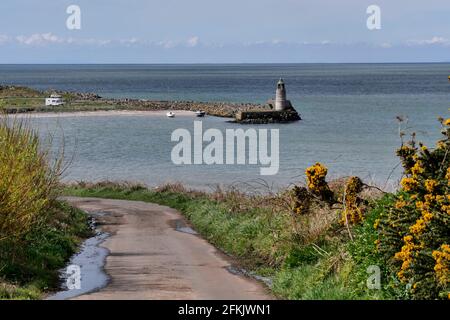 Telford's bell tower stands on the pier at the pretty bay at  Port Logan,Mull of Galloway, Scotland,Uk Stock Photo