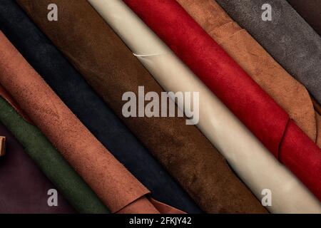 Artificial leather samples on a cow leather background. Top view Stock Photo
