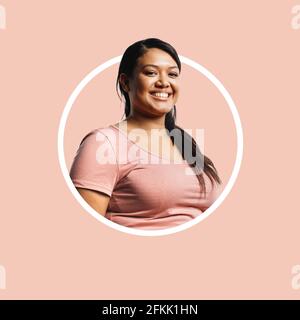 Close up of smiling young woman on pink colour designer background. Cropped shot of woman in circle design. Stock Photo