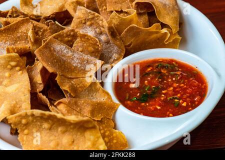 Mexican corn chips with salsa sauce and glass of craft beer on wooden table Stock Photo
