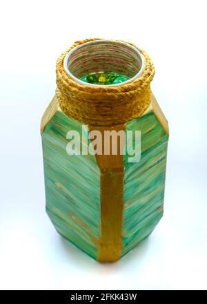 Painted with gold and red paint glass jar of coffee. It turned out to be a colored vase. Stock Photo