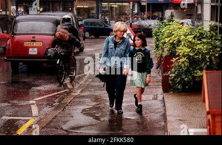 Walking home from The Cavendish school in Camden, Anna Silman (9) with Sonia Kaye who collects her and walks her home. Stock Photo