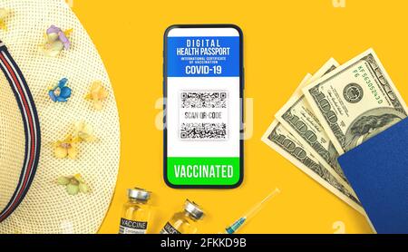 Smartphone displaying a valid digital vaccination certificate passport for COVID-19 coronavirus, concept photo flat lay background for summer vacation Stock Photo