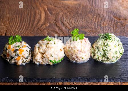 four different dumplings on slate Stock Photo