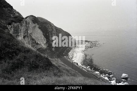 1950s, historical, a view from above on a cliff down to the famlous causeway coastal road, Ireland. Stock Photo