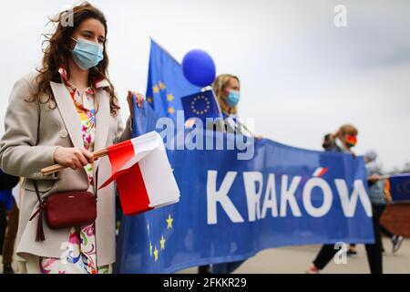 Cracow, Poland. 01st May, 2021. Supporters of the European Union, sceptical about the government's policy are seen with a banner saying Krakow, during the march.Poland is a member of European Union since May 1st 2004. On the 17th anniversary of Poland's membership in the European Union both Polish and European Union flags have been seen displayed on buildings. Opponents of the government's policies marched through city streets with both Polish and EU flags. (Photo by Filip Radwanski/SOPA Images/Sipa USA) Credit: Sipa USA/Alamy Live News Stock Photo