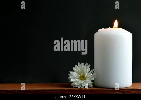 Condolence card with white burning candle and flower Stock Photo