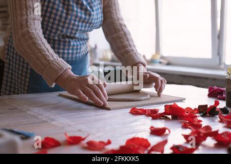 Senior female artisan creating handmade ceramics in pottery studio Stock Photo