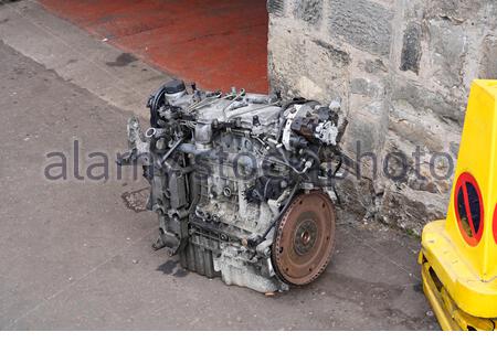 Car Engine block dumped on pavement Stock Photo