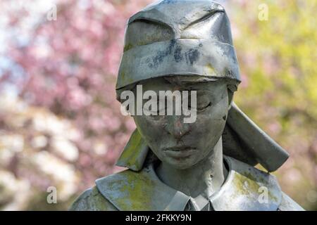 Brampton Park, Newcastle-under-Lyme, Staffordshire, United Kingdom. 02 May 2021. The Lady in the Park - close up view of  the life sized sculpture with blurry cherry blossom in background.  Credit: Eddie Cloud/Alamy Live News. Stock Photo