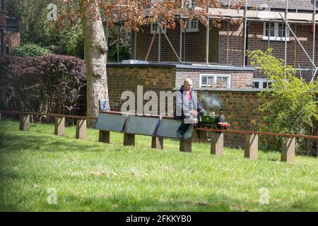 Brampton Park, Newcastle-under-Lyme, Staffordshire, United Kingdom. 02 May 2021. An engineer rides on miniature railway during spring maintenance at sunny afternoon.  Credit: Eddie Cloud/Alamy Live News. Stock Photo