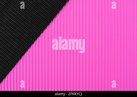 A closeup of black and pink corrugated paper under the lights for textures and backgrounds Stock Photo