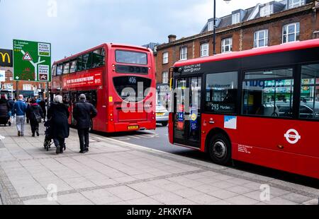Epsom Surrey London UK, May 02 2021, A Single And Double Deck Or Decker Bus Waiting At A Bus Stop for Passengers With Shoppers Walking Past