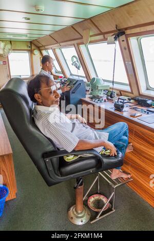 KATCHA RIVER, BANGLADESH - NOVEMBER 19, 2016: Captain of MV Modhumoti ship on the bridge, Bangladesh Stock Photo
