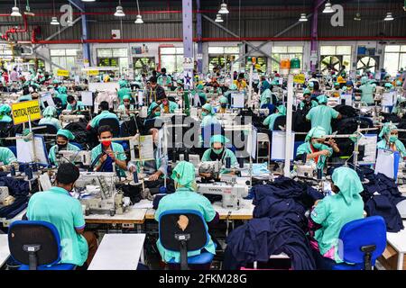Garment workers work in a sewing section of the Fakhruddin Textile Mills Limited in Gazipur, Bangladesh, on May 2, 2021. Stock Photo