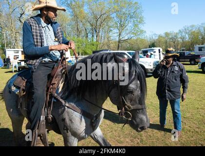 Acto, New Jersey, USA. 1st May, 2021. AL LYNCH of Philadelphia, Pennsylvania talks to his JR Fulmore of the Federation of Cowboys member after a trail ride in Atco, New Jersey. Lynch along with other cowboys and cowgirls, from Maryland, Pennsylvania, New York, and New Jersey participated in the Crazy Faith Riders toiletry fund drive donations for the Mt. Nebo Holy Church Outreach Ministry of Mt. Holly, N.J. Lynch grew up in North Philadelphia in a section called the 'village'' now known as Strawberry Mansion, grew up riding horses and rode out of The Fletcher Street Stables in Philadelphia Stock Photo