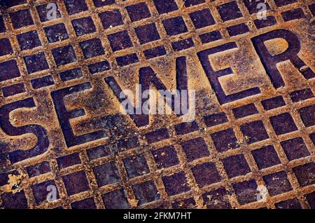 A rusted sewer lid is pictured downtown, April 25, 2021, in Moss Point, Mississippi. Stock Photo