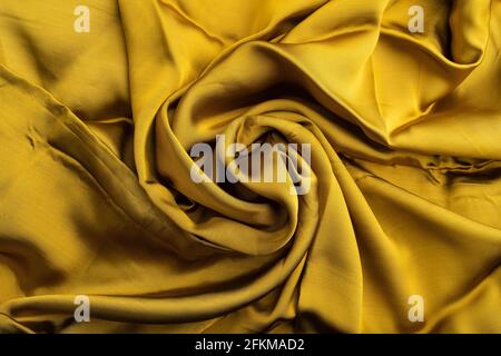 Fragment of yellow and green tissue. Side view, synthetic textile background and texture. wave concept, abstract. Stock Photo