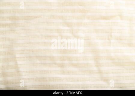 Fragment of smooth white linen tissue. Top view, flat lay, natural textile background and texture. Stock Photo