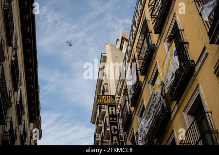 A police helicopter flies over the Hostal Cantabrico on Calle de la Cruz, 3 and 5 'La Ingobernable' which was an occupied and self-managed neighborhood social center. This morning, dozens of activists of La Ingobernable entered illegally and occupied another abandoned building in the Madrid downtown. The building is located on Calle de la Cruz 3 and 5, abandoned since 2016 and owned by the Fernández Luengo brothers, known for their Marco Aldany franchise. Despite the eviction attempts by the Spanish Police, dozens of protesters were able to prevent it. Stock Photo