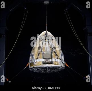 The SpaceX Crew Dragon Resilience spacecraft is lifted onto the GO Navigator recovery ship after it landed with NASA astronauts Mike Hopkins, Shannon Walker, and Victor Glover, and Japan Aerospace Exploration Agency (JAXA) astronaut Soichi Noguchi aboard in the Gulf of Mexico off the coast of Panama City, Florida, Sunday, May 2, 2021. NASA's SpaceX Crew-1 mission was the first crew rotation flight of the SpaceX Crew Dragon spacecraft and Falcon 9 rocket with astronauts to the International Space Station as part of the agency's Commercial Crew Program. Mandatory Credit: Bill Ingalls/NASA via Stock Photo