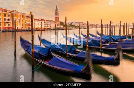 Evening atmosphere, sunset at the Grand Canal, gondolas at the pier, Campanile bell tower, Venice, Veneto region, Italy Stock Photo