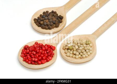 Black pepper, red pepper and white pepper, wooden spoon, wooden spoon Stock Photo