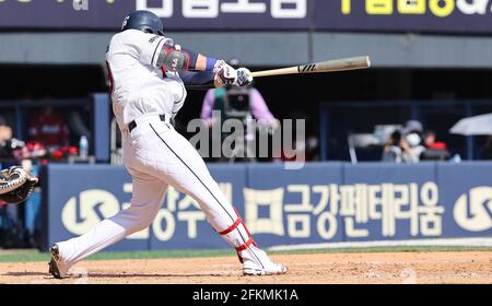 Outfielder Kim In-Tae of Doosan Bears scores a run into the home