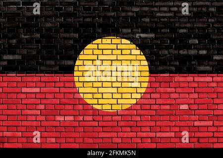 flag of Aboriginal Australians painted on brick wall Stock Photo