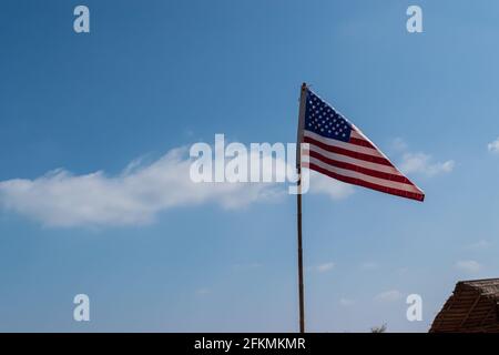 Flag of United States of America on the blue sky and cloud background Stock Photo
