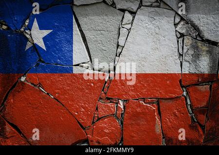 National flag of Chile  depicting in paint colors on an old stone wall. Flag  banner on broken  wall background. Stock Photo