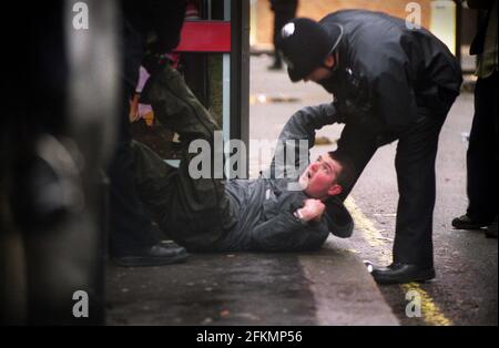 London Mayday Demonstrations 2001  Police subdue a man  on the streets in the West End during the evening of the mayday protest Stock Photo