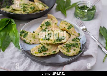 Pierogi ruskie, Baked dumplings stuffed with curd cheese and potatoes and wild garlic Stock Photo