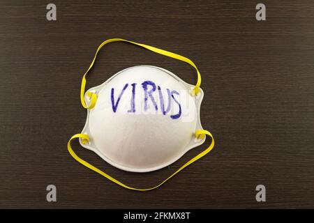 Close up of white mask stack  and word H1N1 in mask on black wooden  background,touch-up in prevention of virus Stock Photo