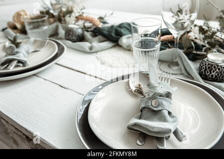 Festive table setting at home with Scandinavian decorative details close up. Stock Photo