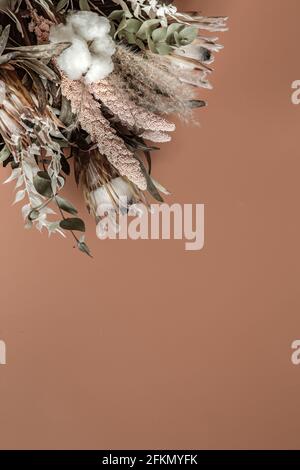 Bouquet of dried wildflowers, cotton and leaves flat lay. Stock Photo