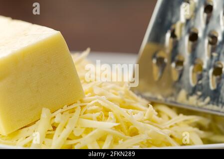 Cheese and Grated cheese, close-up. blurred background Stock Photo