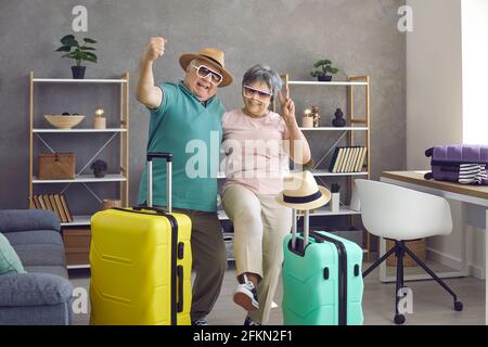Happy active senior couple having fun at home before going on holiday trip together Stock Photo