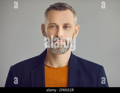 Handsome caucasian hipster man with beard face portrait on grey background Stock Photo