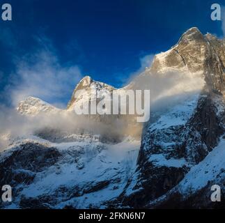 Early morning golden hour sunlight on snowy mountains in Romsdalen valley, Rauma kommune, Møre og Romsdal, Norway, Scandinavia. Stock Photo