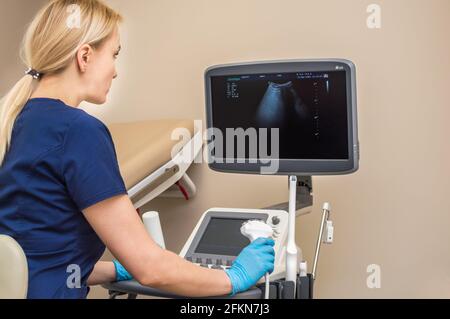 gynecologist makes an ultrasound of the pelvic organs. Stock Photo