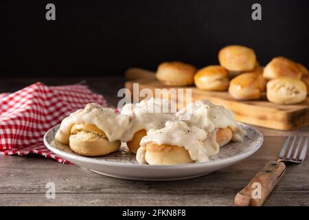 Traditional American biscuits and gravy for breakfast on wooden table Stock Photo