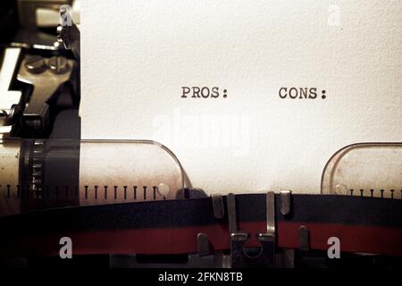 Pros and cons words written with a typewriter. Stock Photo