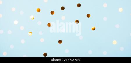 Festive light blue background with golden confetti Stock Photo