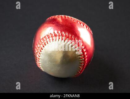 Red and silver Baseball ball isolated on black Stock Photo