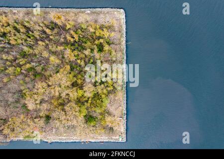 Island with square-shaped trees in a body of water, aerial drone aerial photo. Stock Photo