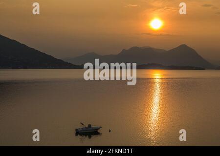View of sunrise and boat on Lake Maggiore, Lago Maggiore, Piedmont, Italy, Europe Stock Photo