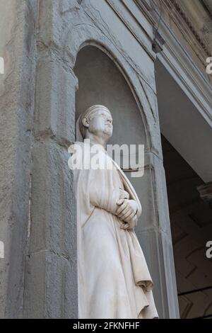 Building facade with typical statue of saint in Italy, Venice, Florence Stock Photo