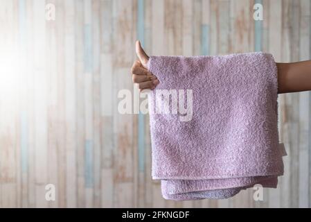 Man showing thumb up with towel hanging on his hand. Concept of hygiene and freshness Stock Photo