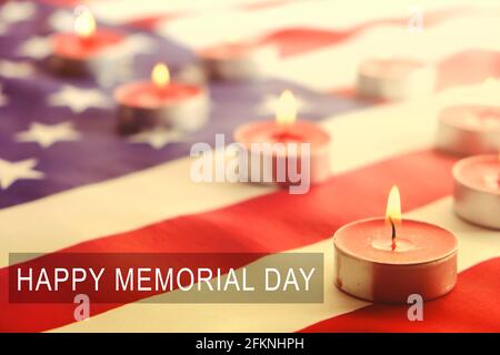 Mourning candles burning on USA American national flag background. Greeting happy memorial day card, weekend, patriot veterans day. Moment of silence Stock Photo